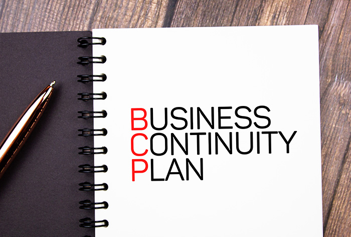 Image of a handbook labelled "Business Continuity Plan" that indicates a BCP is an important part of any Business Continuity Strategy